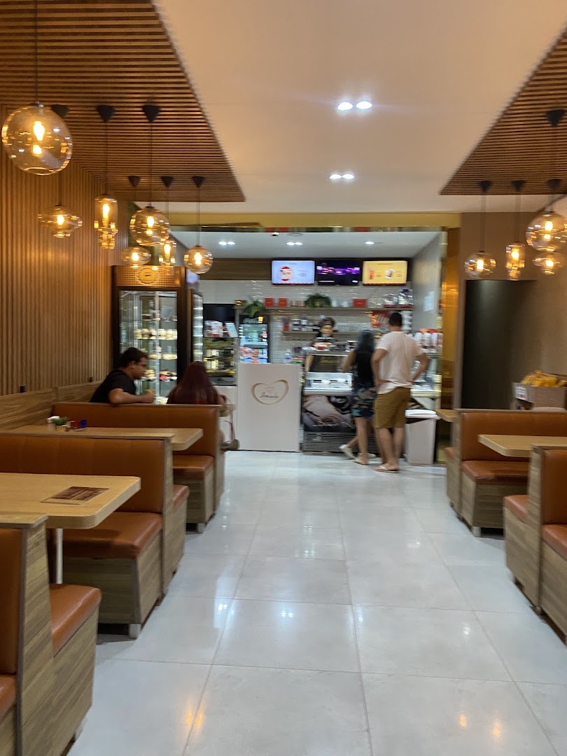 Interior da cafeteria com mesas e luz quente