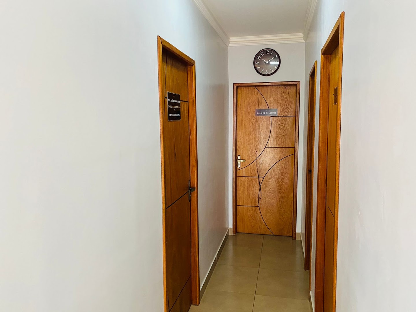 Corredor interno do escritório com porta de madeira