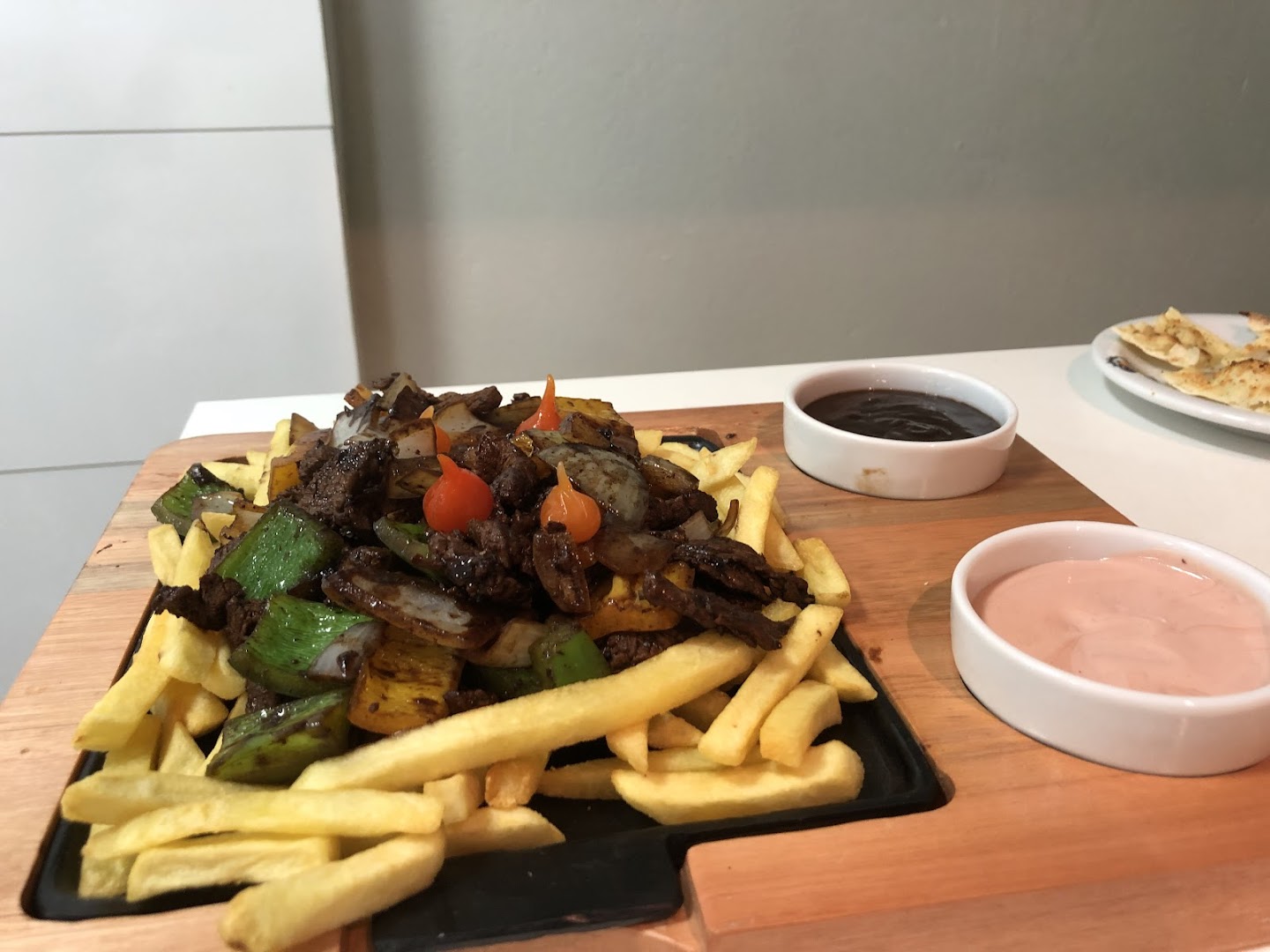 Carne com fritas e legumes servida na tábua