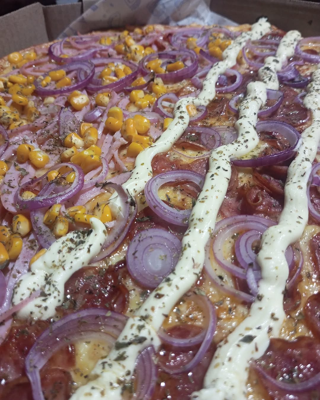 Pizza carregada de milho e cebola roxa